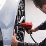Land Rover Mechanic tightens lug nut