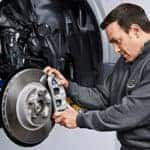 Land Rover Mechanic adjusting brake caliper