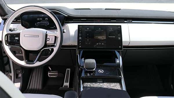 2025 Range Rover Sport interior showcasing advanced technology features, including a digital display, premium controls, and intuitive infotainment system.