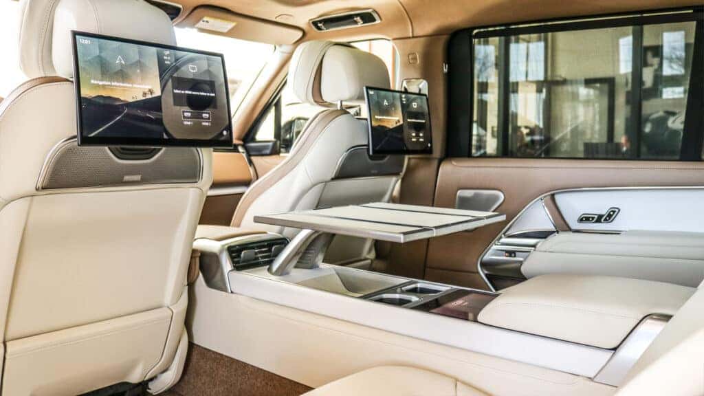 Front view of the 2025 Range Rover showcasing its sleek design, signature grille, and modern LED headlights, parked in a luxury setting.