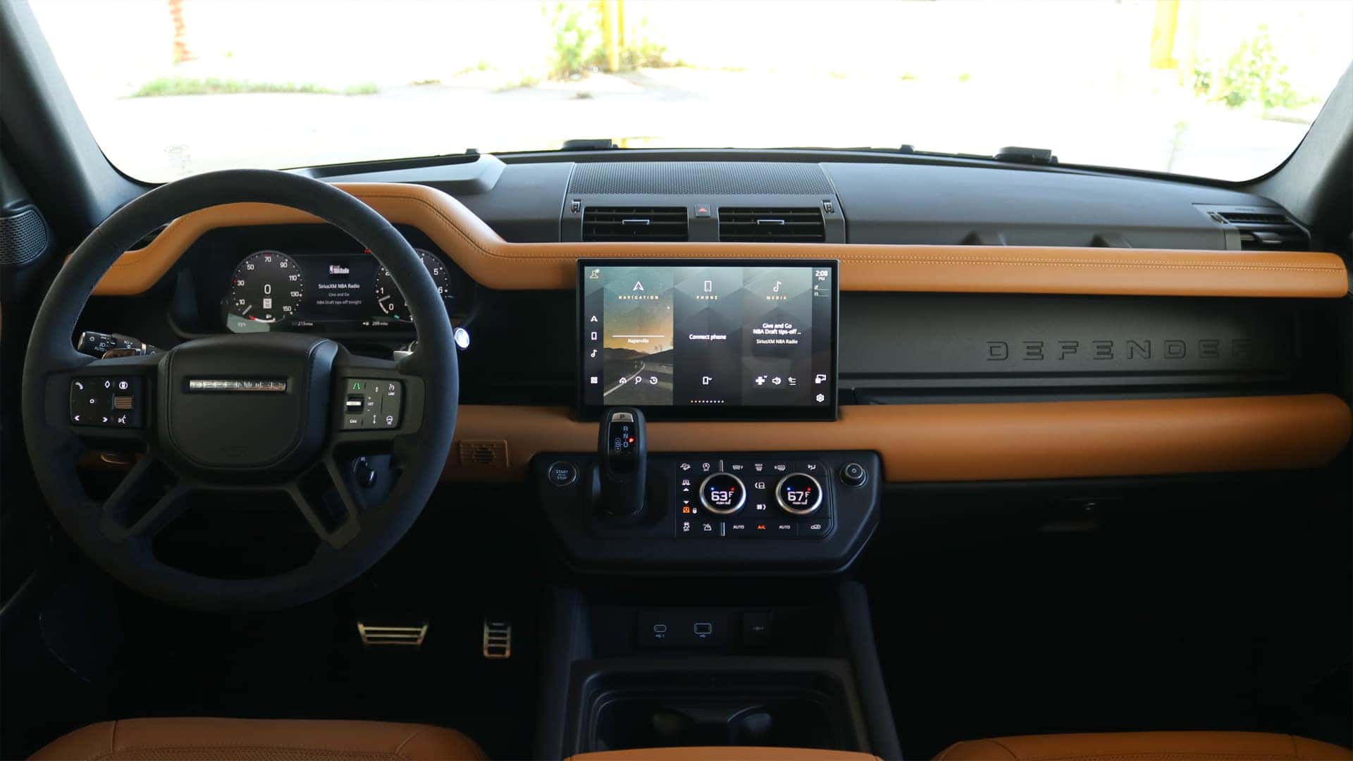 Interior view of the 2025 Land Rover Defender showcasing the 13.1-inch Pivi Pro touchscreen, digital driver display, and integrated advanced off-road technology features.