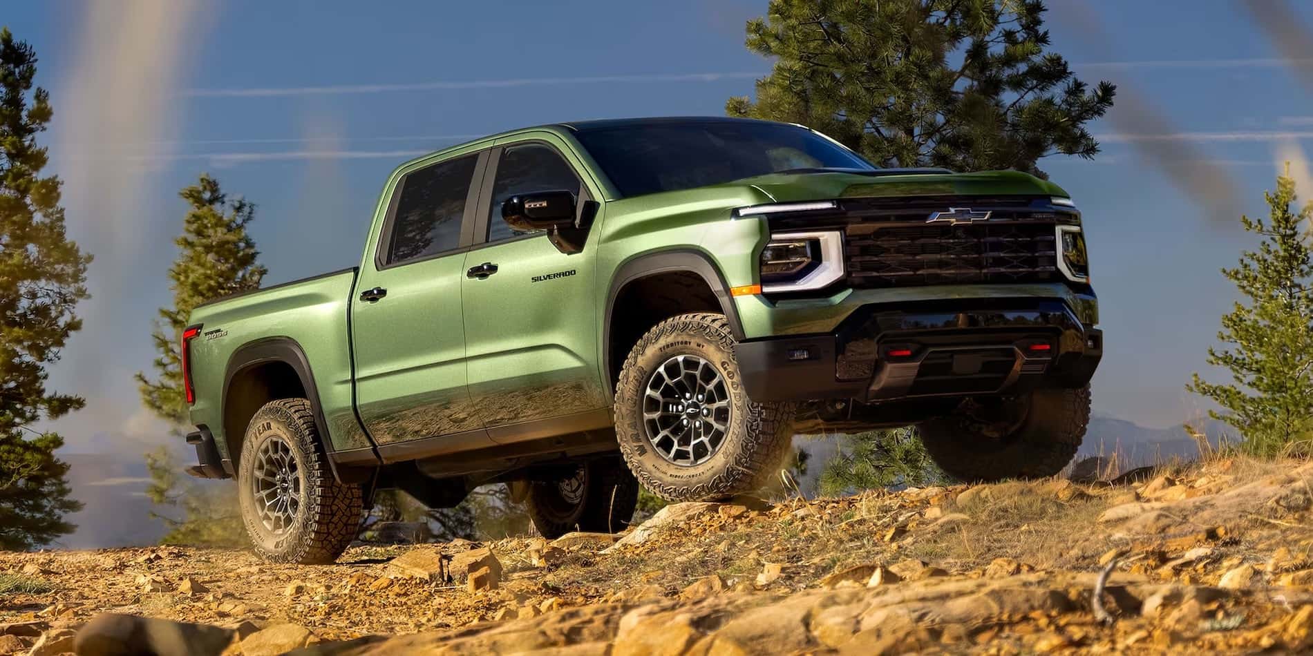 Green 2027 Chevrolet Silverado 1500 Trail Boss exterior in rocky terrain