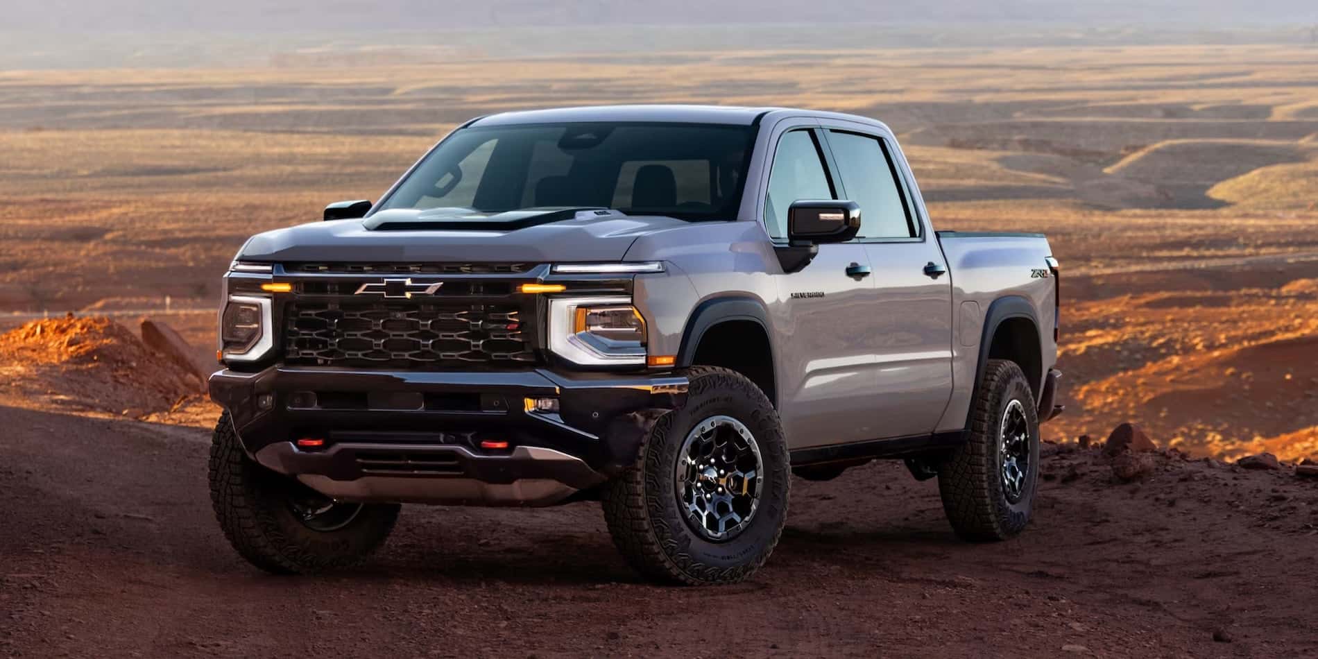 Gray 2027 Chevrolet Silverado 1500 ZR2 exterior front view in desert terrain