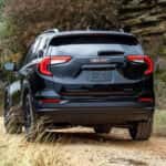 Black 2024 GMC Terrain SLT Elevation driving on a trail