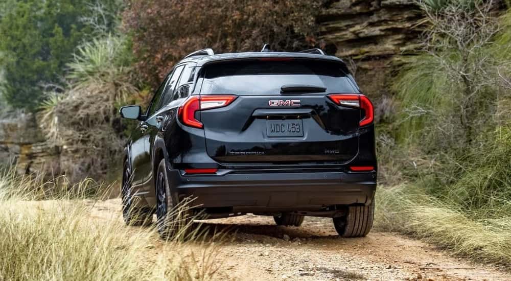 Black 2024 GMC Terrain SLT Elevation driving on a trail