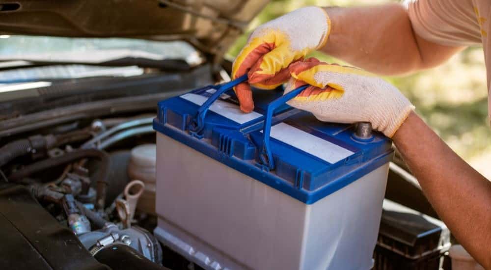 Technician replacing a battery at a Buick service center