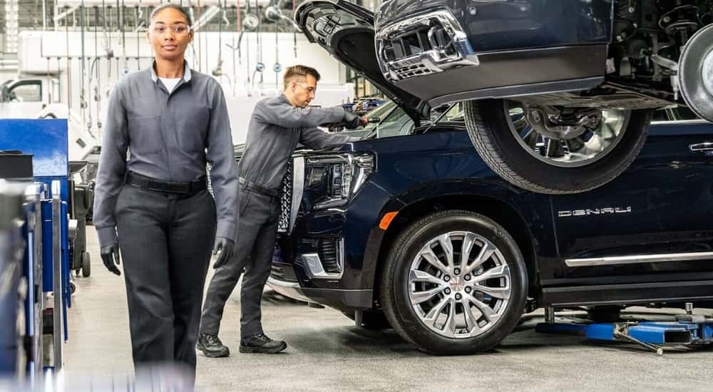 Technician servicing a 2021 GMC Yukon Denali at a GMC service center in Cincinnati