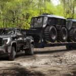 A black 2025 GMC Sierra 3500HD towing SHERPs