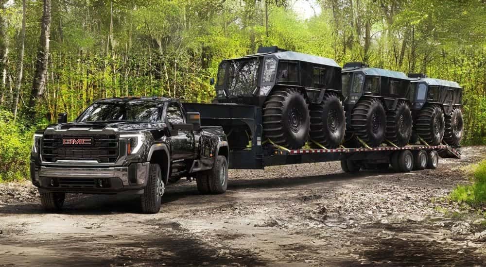 A black 2025 GMC Sierra 3500HD towing SHERPs