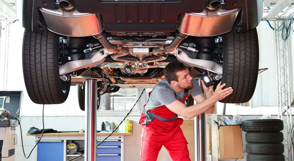 Technician inspecting a vehicle on a lift