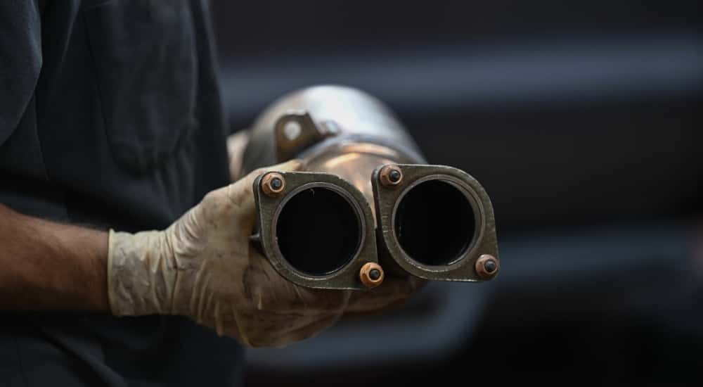 A technician holding a catalytic converter