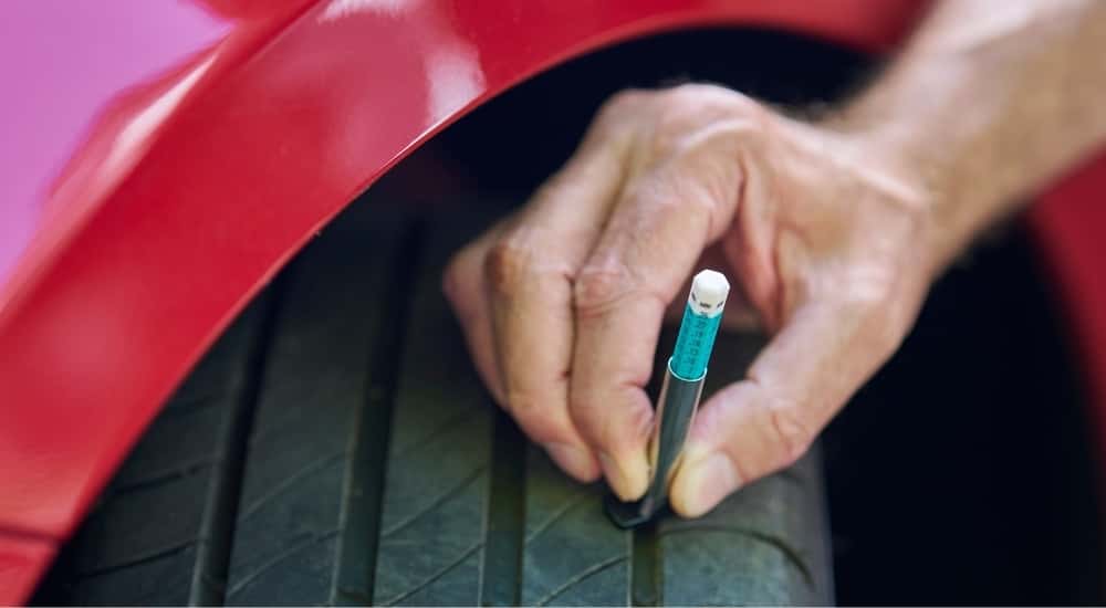 Technician check a tires tread depth