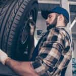 Technician changing a tire GMC service center near Covington