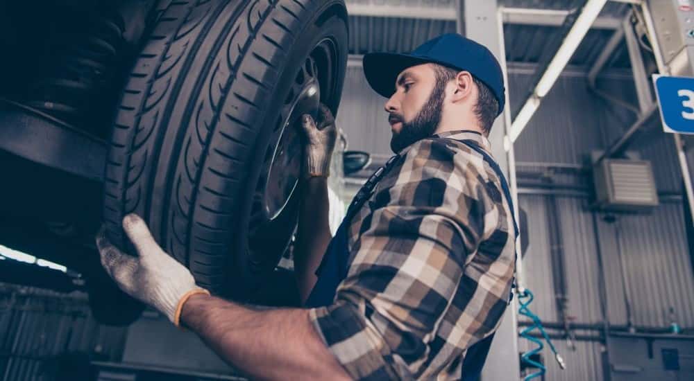 Technician changing a tire GMC service center near Covington