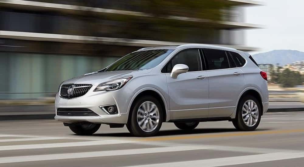 Silver 2019 Buick Envision driving on a city street