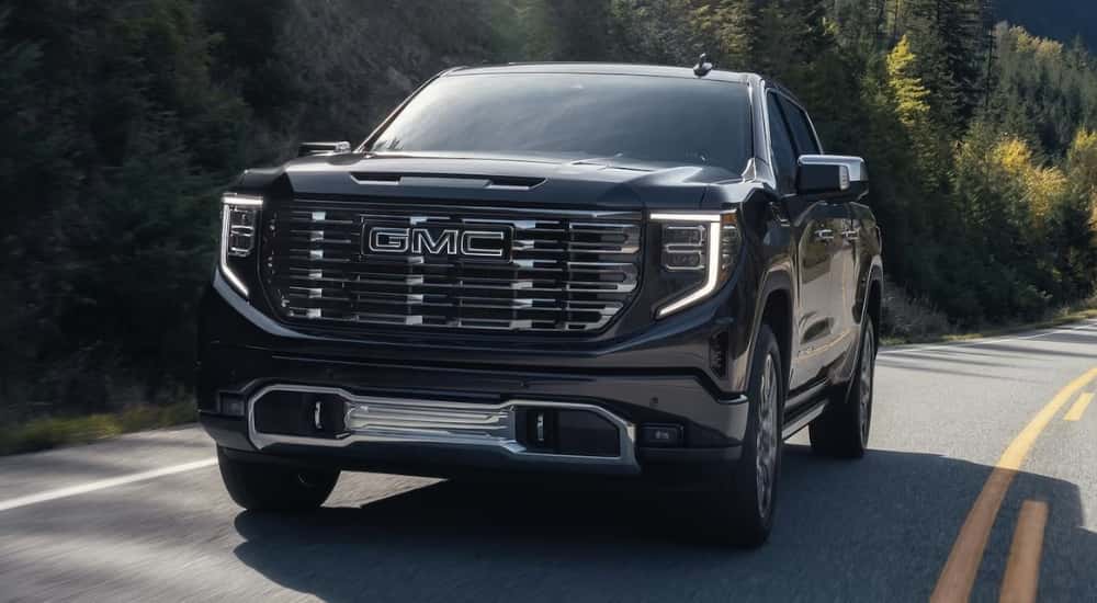 Black 2025 GMC Sierra 1500 Denali driving on a highway
