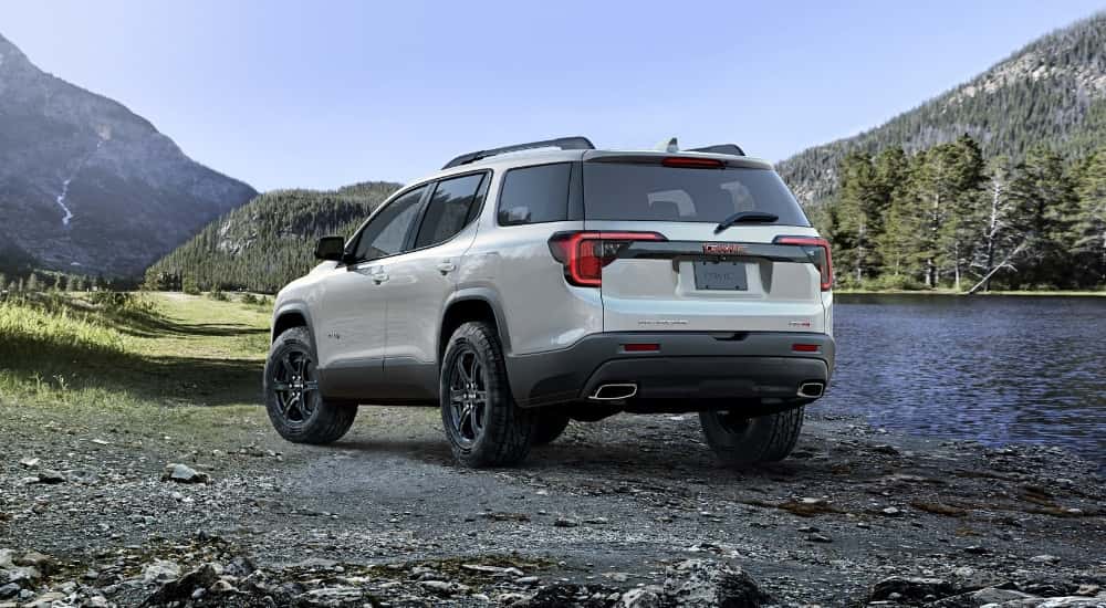 White 2023 GMC Acadia parked near a river