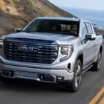 Silver 2024 GMC Sierra 1500 driving to a GMC service center near Monroe