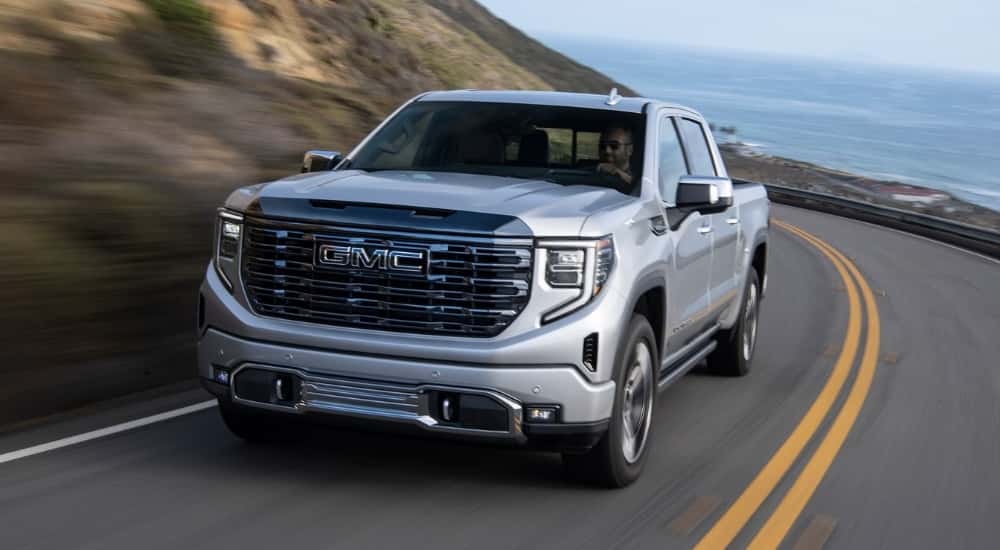 Silver 2024 GMC Sierra 1500 driving to a GMC service center near Monroe