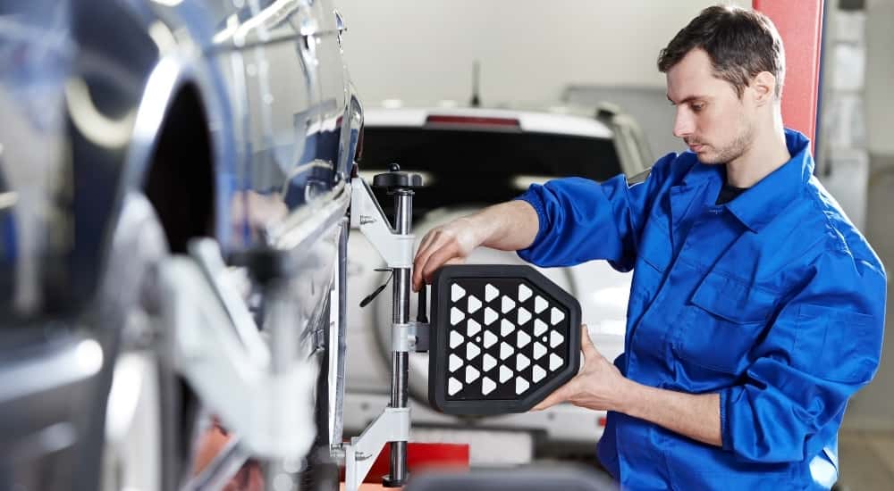 Technician doing a wheel alignment