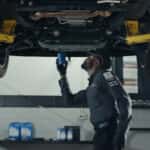 Technician installing an oil filter at a GMC service center