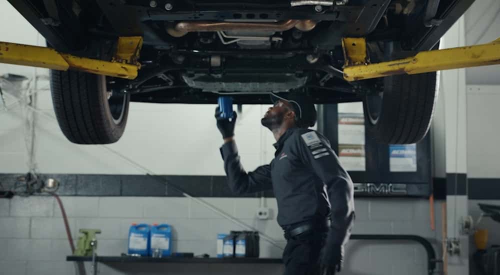 Technician installing an oil filter at a GMC service center