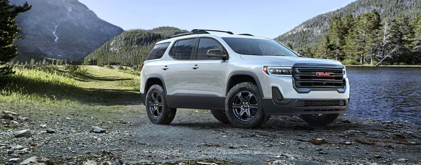 White 2023 GMC Acadia AT4 parked by a alke