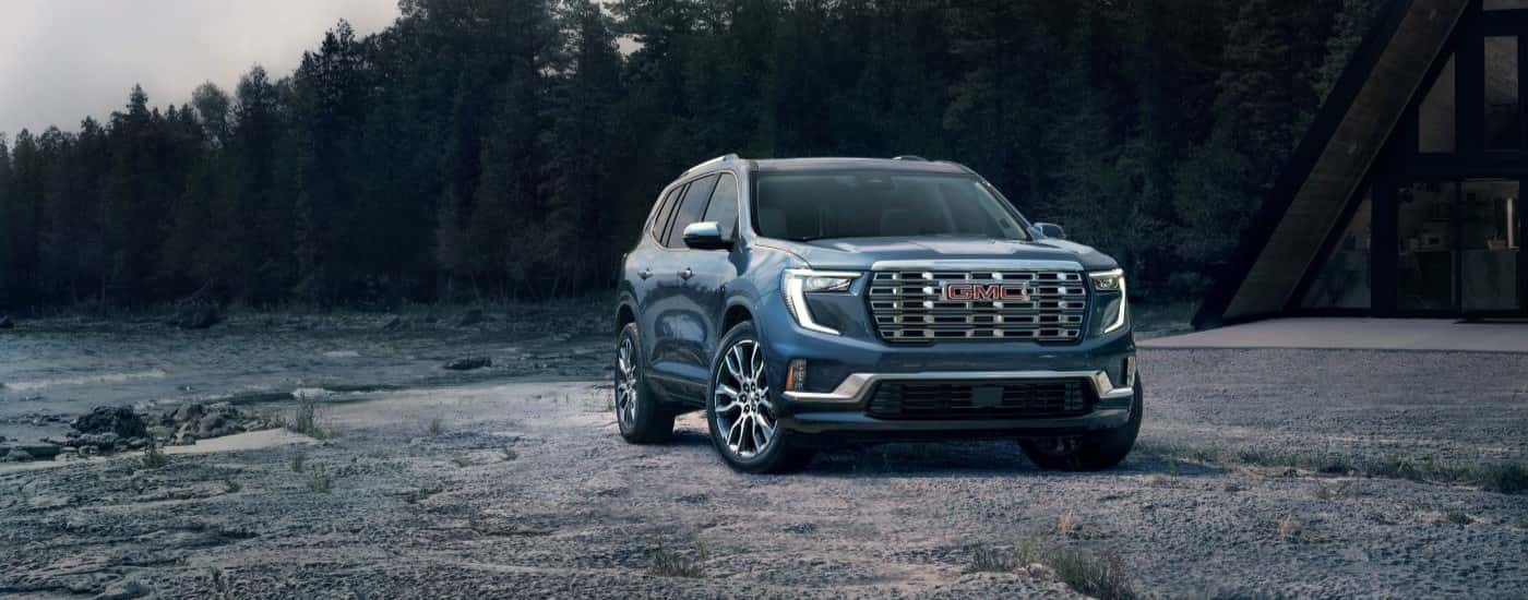 Blue 2026 GMC Acadia parked off-road