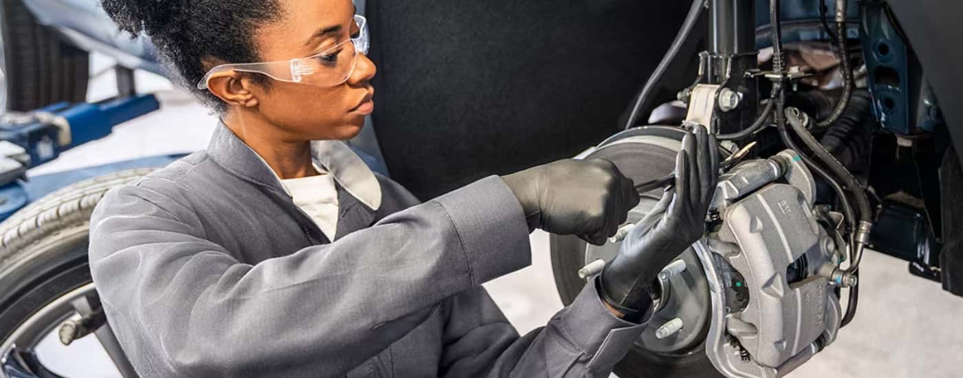 Technician at a Buick service center in Cincinnati performing brake service