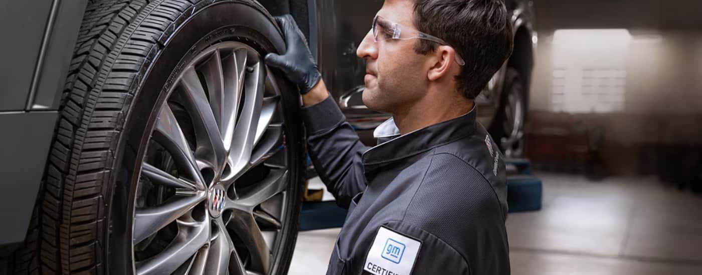 Technician inspecting a vehicle at Buick service center near Covington
