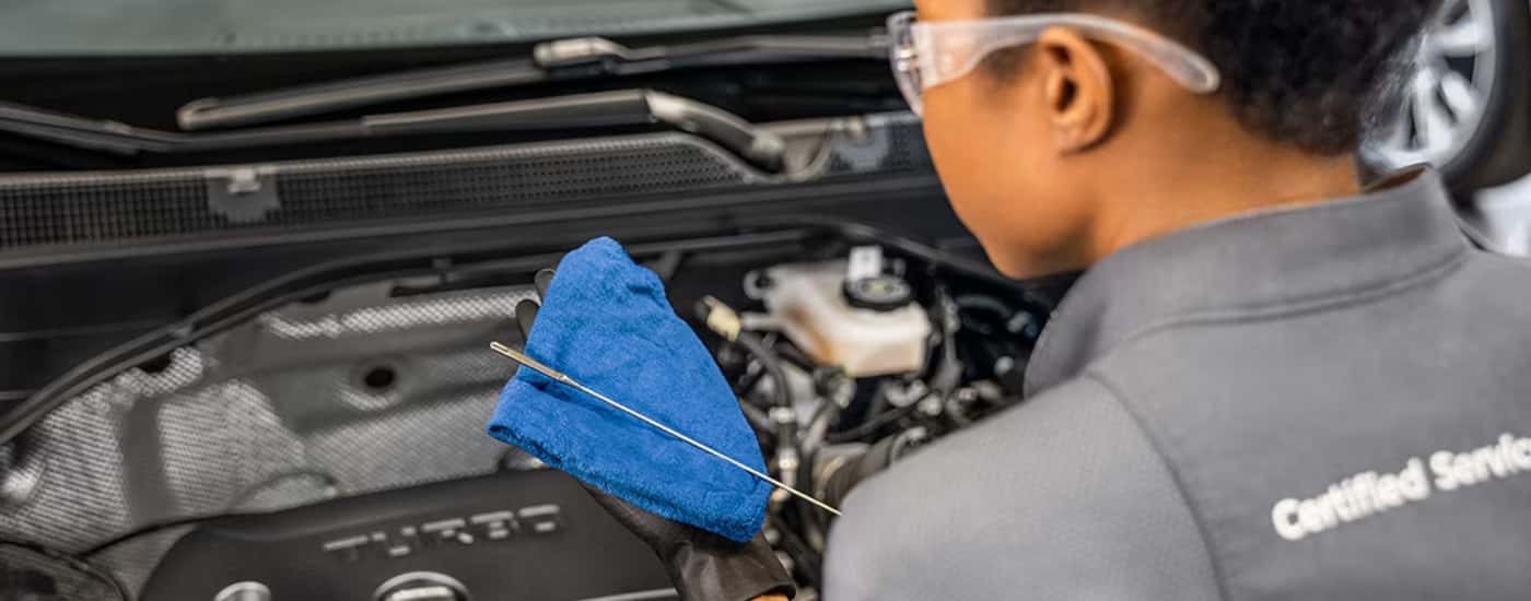 Technician performing an oil change at a Buick service center near Florence