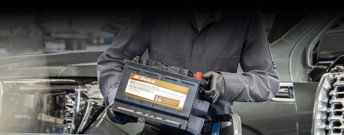 Technician carrying a battery