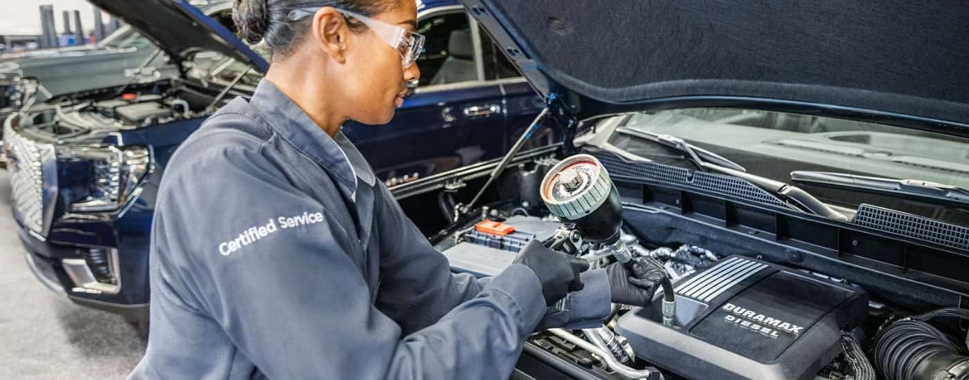 Technician working on a vehicle at a GMC service center near Florence