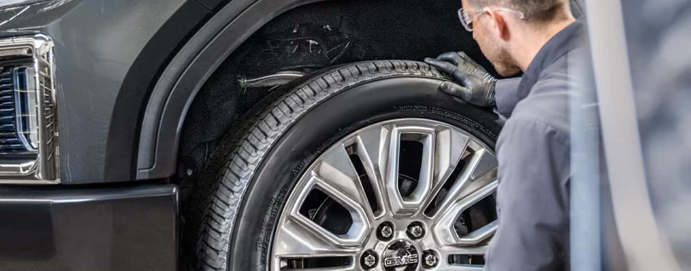 Technician checking tire tread
