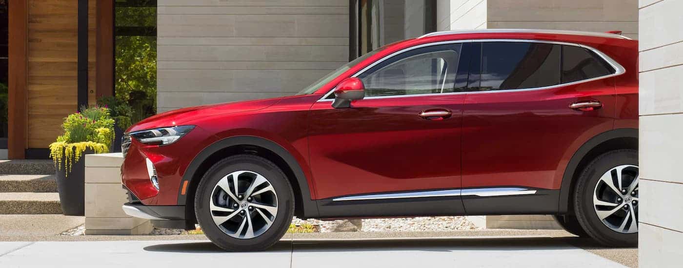 Red 2023 Buick Envision parked in front of a building.