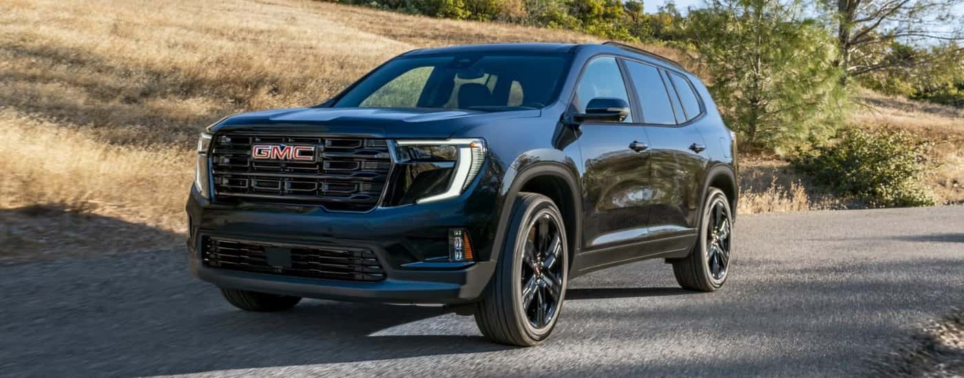 Black 2026 GMC Acadia Elevation on an open road