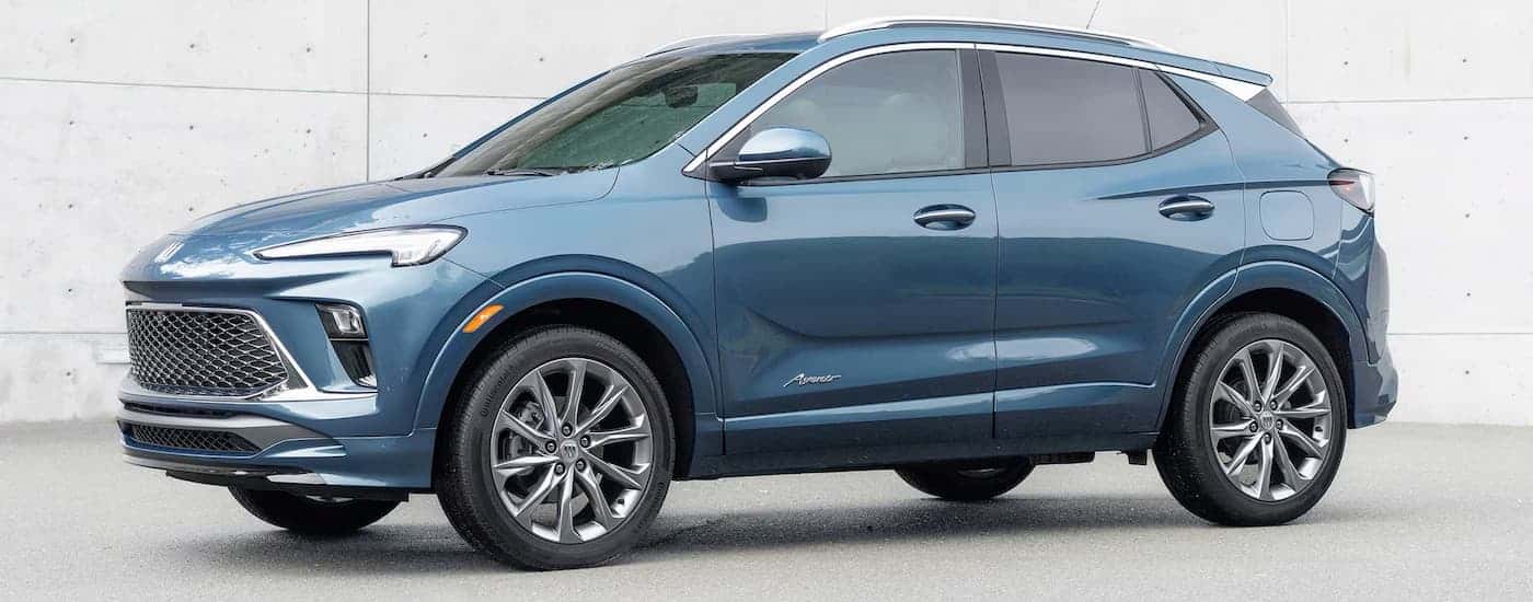 Blue 2026 Buick Encore GX parked in front of a wall.