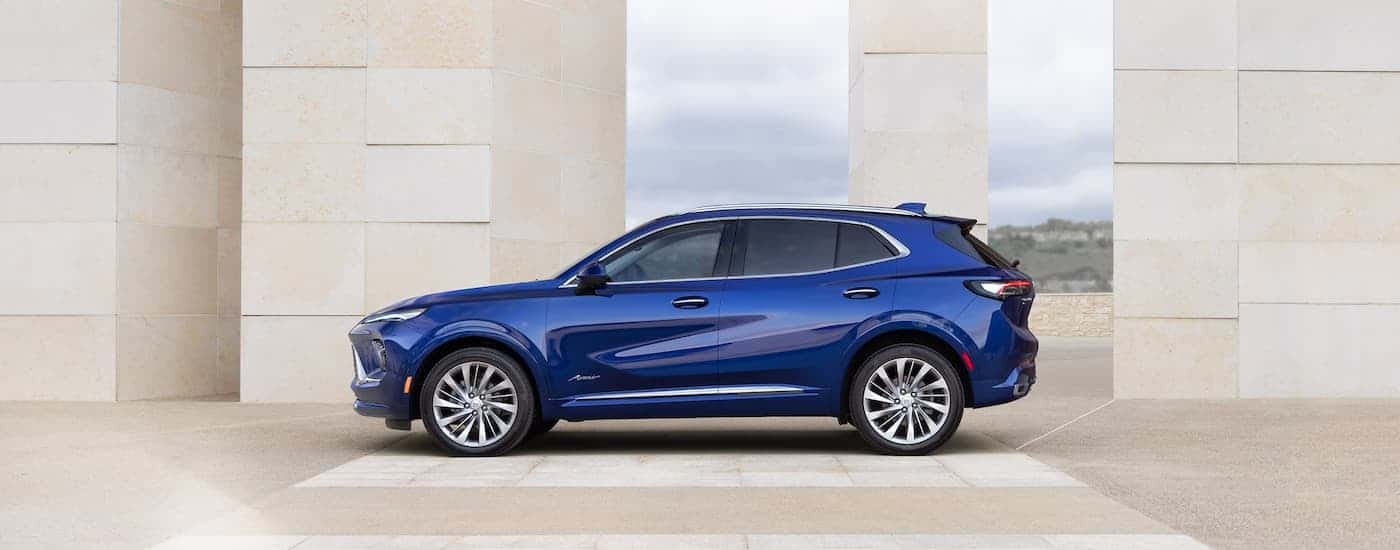 Side of a blue 2026 Buick Envision parked by a wall.