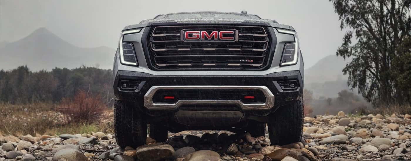 Grey 2026 GMC Yukon AT4 driving to a GMC dealer near Milford