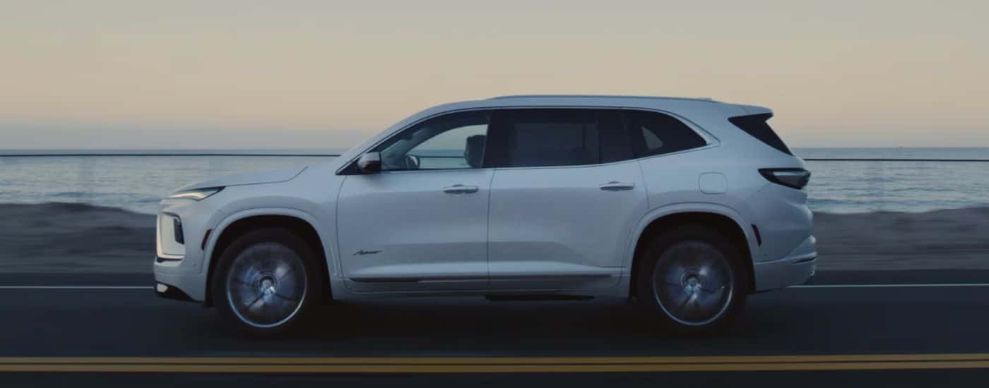 White 2026 Buick Enclave side view on the road.