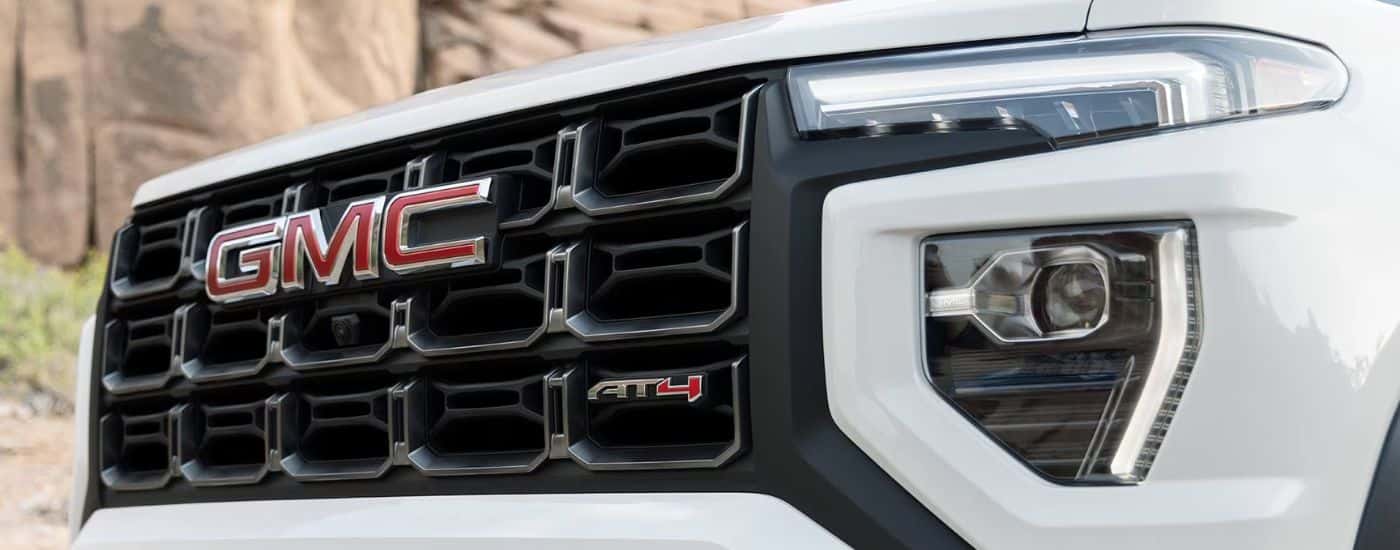Close up of the front grille on a white 2026 GMC Canyon AT4.
