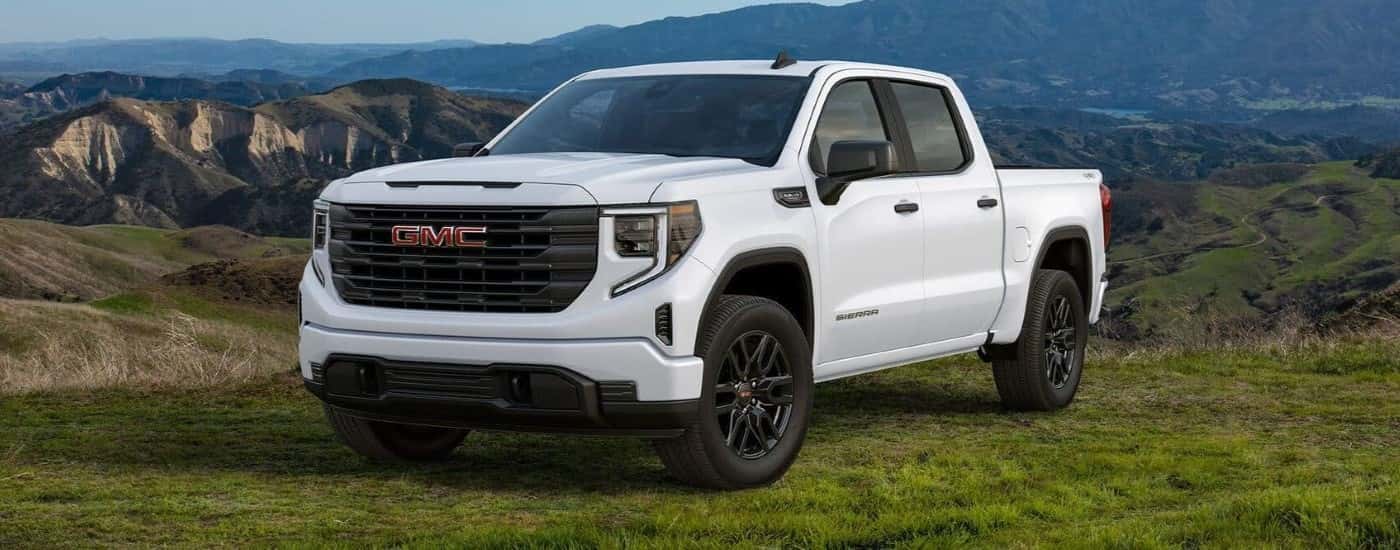A white 2024 GMC Sierra 1500 Pro Graphite Edition parked at an overlook.