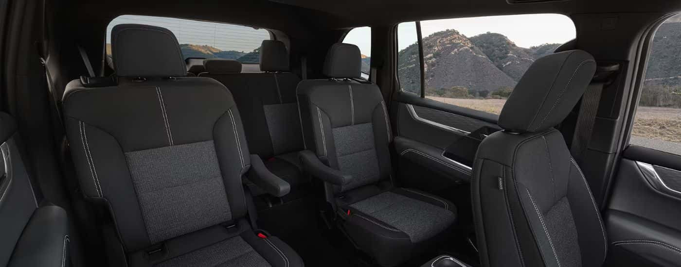 Black three-row interior of a 2026 GMC Acadia.