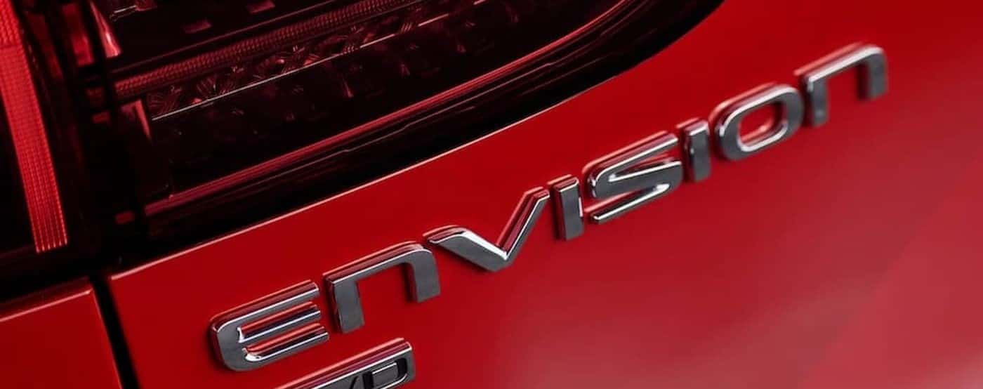 Envision badge on a red 2026 Buick Envision.