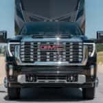 A black 2026 GMC Sierra 3500 HD towing a trailer.