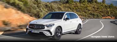 A white Mercedes-Benz GLC SUV Driving down the road.