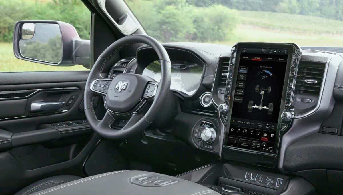 Steering wheel and tall Uconnect touchscreen inside a 2026 Ram 1500 Rebel