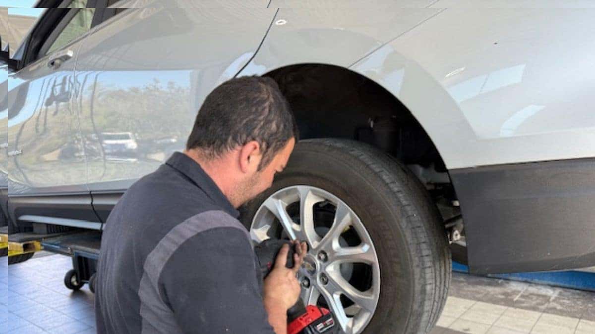 Chevrolet technician performing routine vehicle maintenance at New Smyrna Beach Chevrolet service department