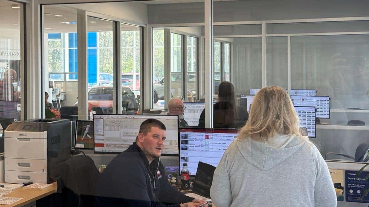 Customer discussing vehicle financing options with advisor at New Smyrna Beach Chevrolet in Florida