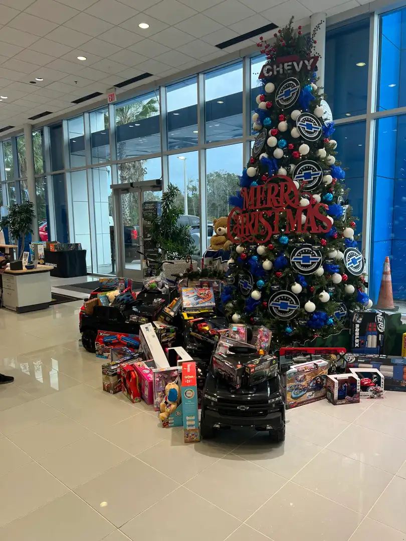Corvette Christmas toy drive display inside New Smyrna Beach Chevrolet